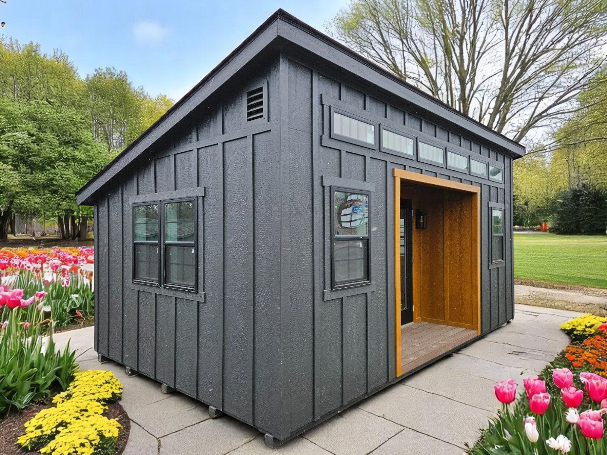 Modern dark-stained studio shed with single-slope roof and large windows